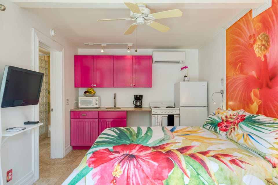 The Hibiscus Suite boasts a playful design, kitchenette, queen-size bed, and a full bathroom.
