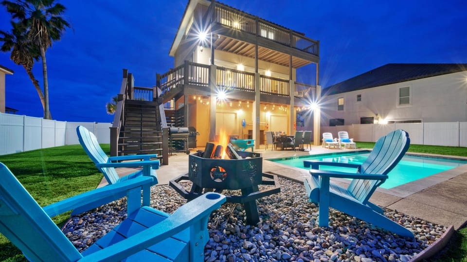 Outdoor oasis with a pool, firepit, and lounge space.