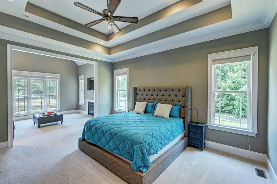 Primary bedroom features a king bed, and a sitting area with a full-size sleep sofa and fireplace.