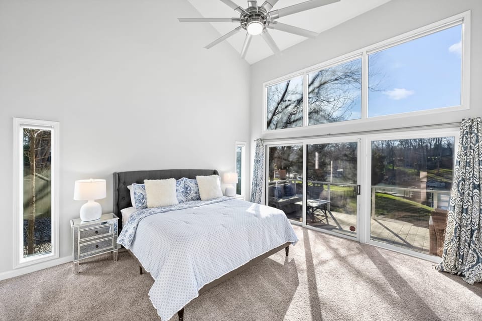 Main-level master bedroom with private sliding doors to the main deck &amp; en suite bathroom.
