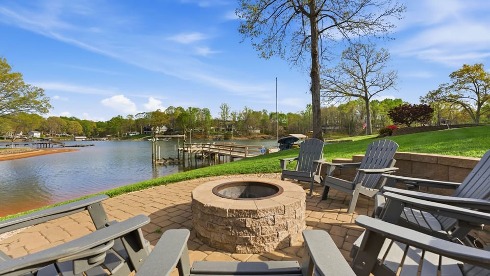 Lakeside fire‑pit patio with Adirondack seating and peaceful water views.