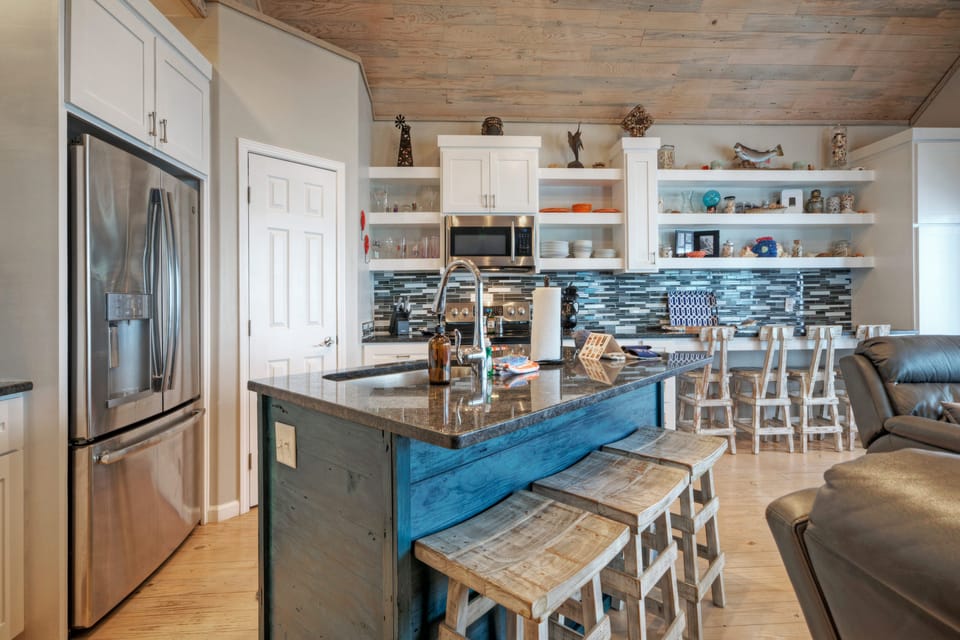 Modern kitchen with an island and barstool seating.