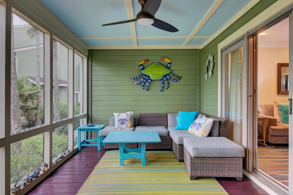 Large screened-in porch with multiple seating options for relaxation and gathering.