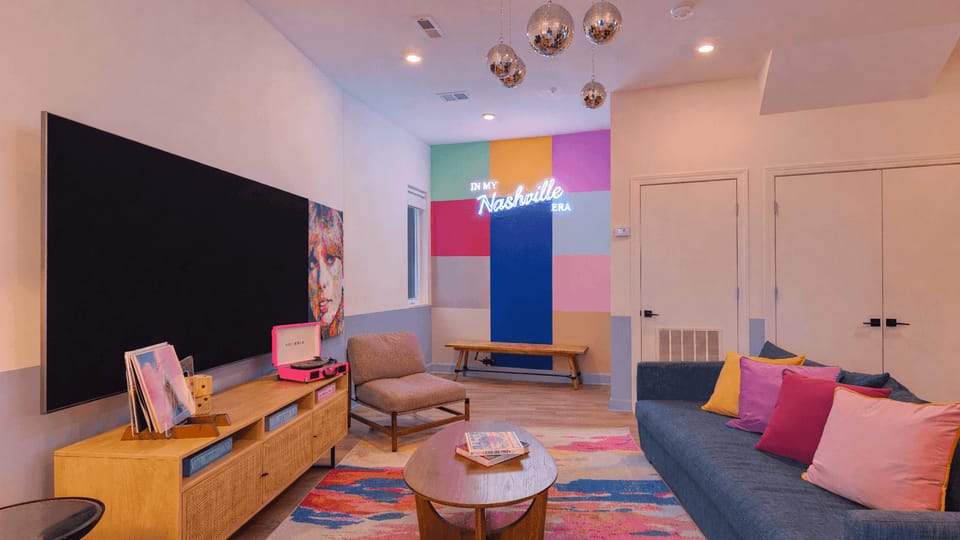 Living room with flat-screen TV and colorful design.