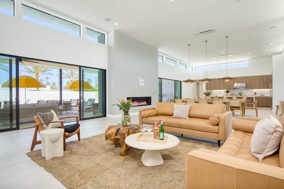 Open layout featuring a spacious dining area, comfortable living area, and a fireplace.