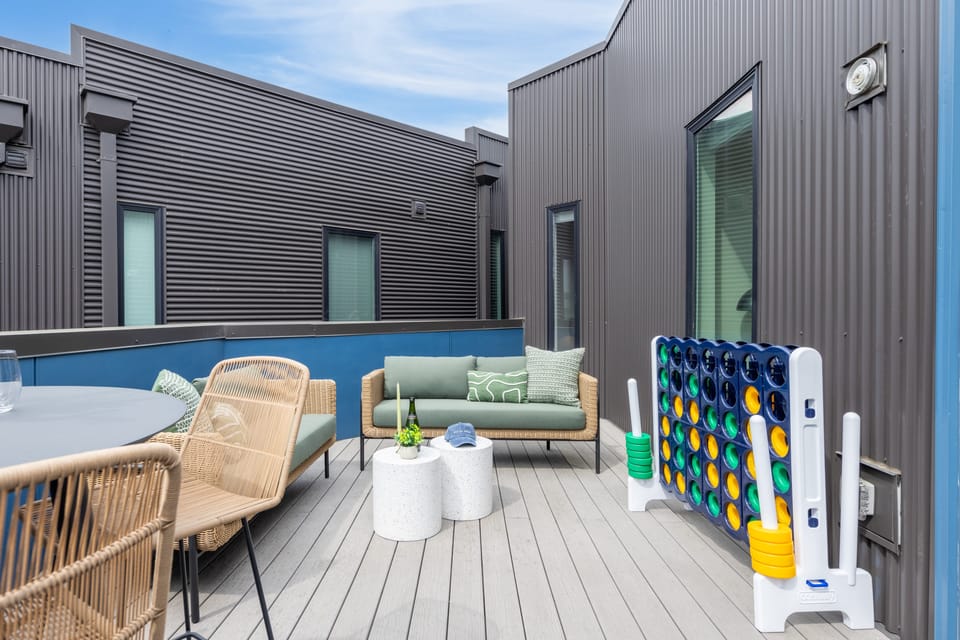 Outdoor space with seating, an al fresco dining area, and Giant Connect 4.