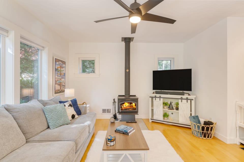Bright and chic living room featuring a fireplace and a TV.