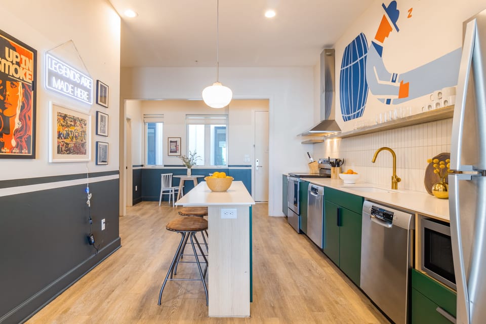 Kitchen features an island with barstool seating.