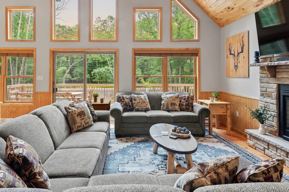 Vaulted ceilings and large windows in the living area.