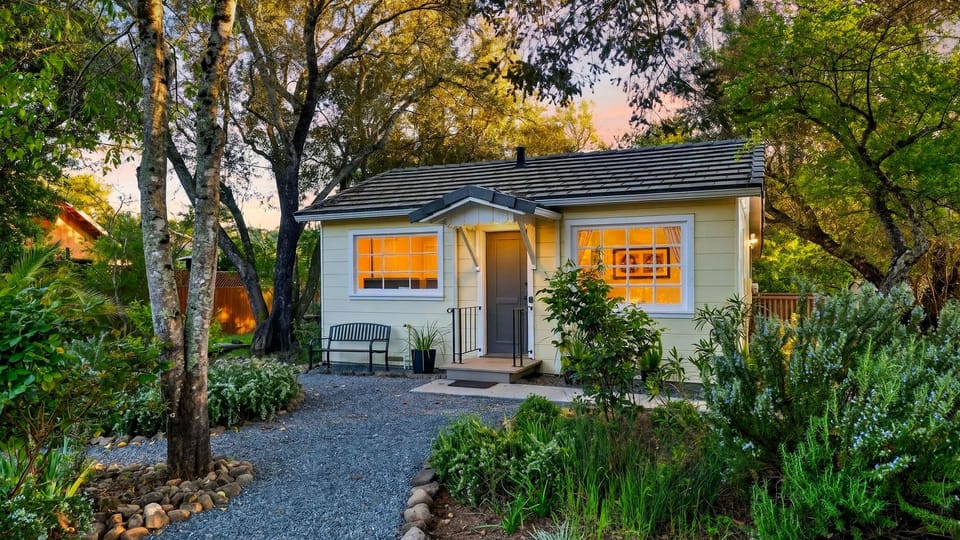 Charming exterior surrounded by vibrant flowers.