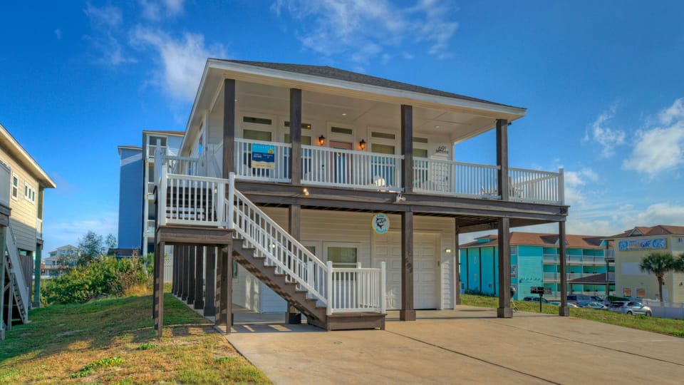 Classic coastal charm—this elevated beach home features breezy porches, covered parking, and an ideal layout just moments from the shore.