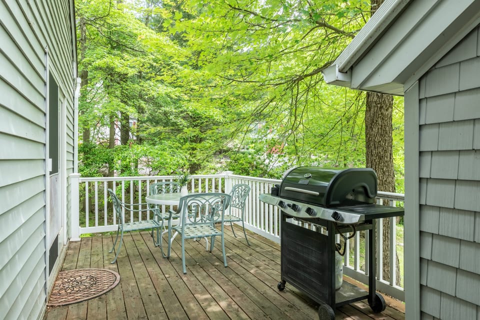 Patio with outdoor dining and a BBQ grill.
