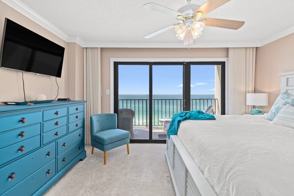 Primary bedroom features a king bed,TV, ensuite bath, and access to the balcony.