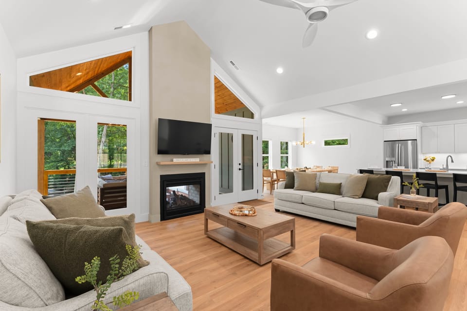 Living room with lake views, fireplace and TV!