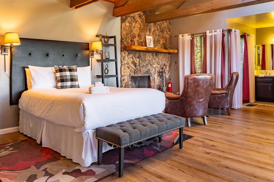 Primary bedroom features a queen bed, TV, balcony, and ensuite bathroom.