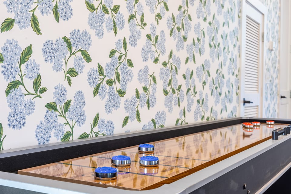 Challenge friends and family to endless fun on the sleek Shuffleboard table.
