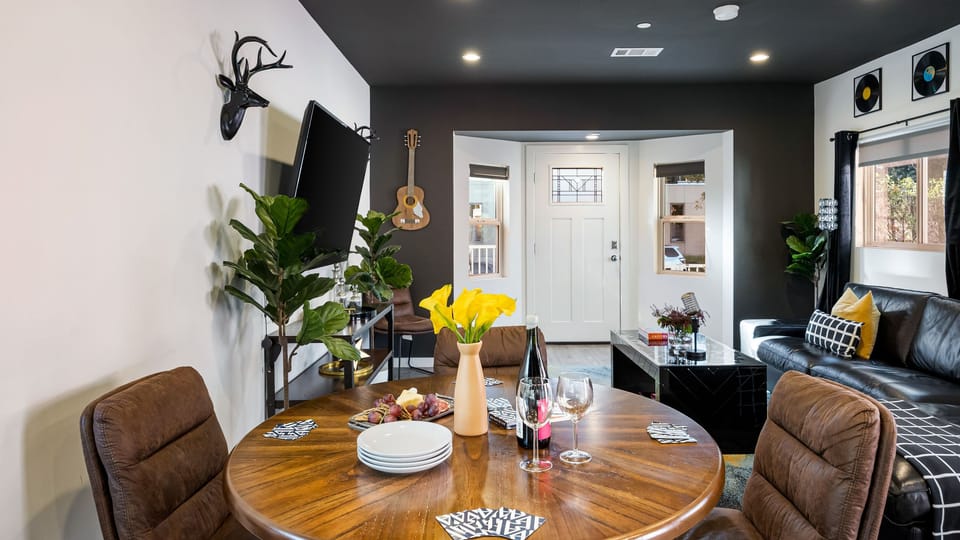 Modern dining nook set within an open-concept living space, featuring a round table for easy gatherings, stylish décor, and seamless flow into the cozy lounge area.
