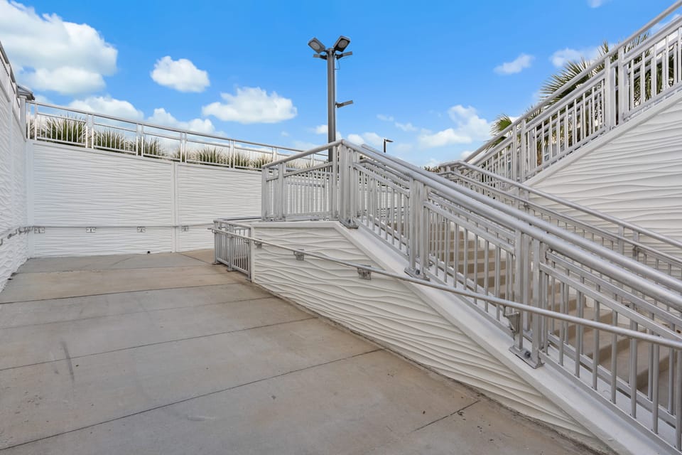 Easy-access boardwalk with stairs and ramp—smooth, convenient path to the beach for everyone.