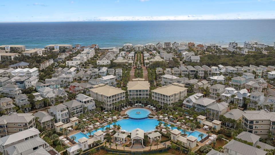 Wide aerial shot of the community pool and surrounding homes.