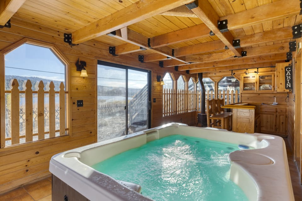 Indoor hot tub with lake views – relaxation starts here.