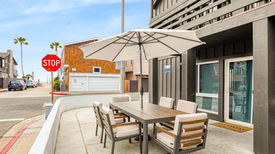Street-facing patio with shaded outdoor dining, just moments from the sand and coastal neighborhood sights.