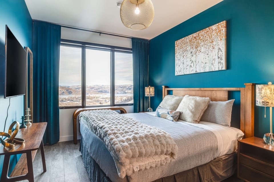 Bedroom features a king bed and TV.