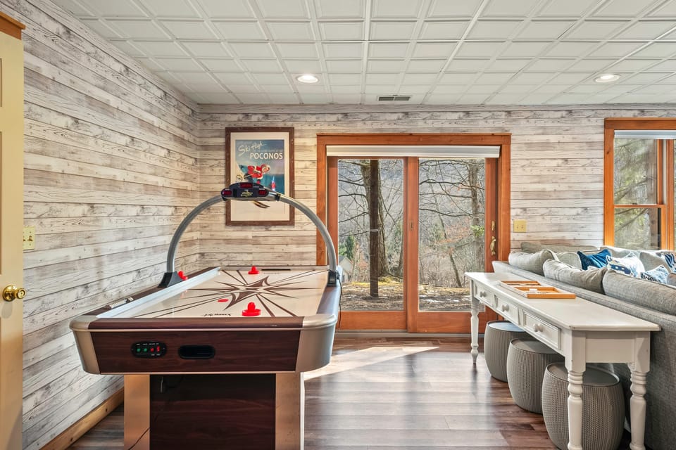 Air hockey and a pool table in the game room.