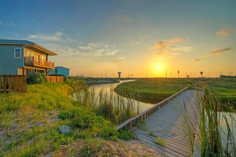 Golden hour along the boardwalk—peaceful marsh views and coastal sunsets just steps from your stay.