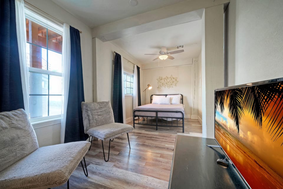 The primary bedroom features a queen bed, TV and an ensuite bathroom.