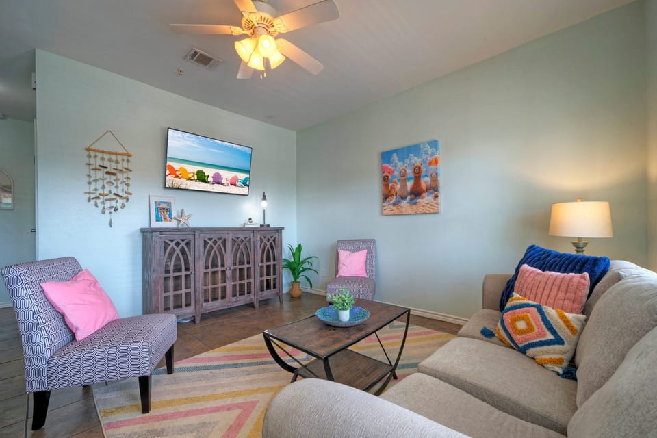 The living area features a coastal interior design and a sleep sofa for additional guests.