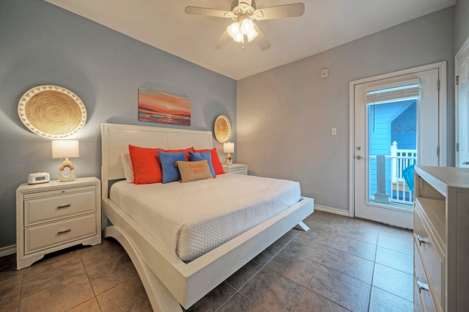 The primary bedroom features a king bed, TV, access to the balcony, and an ensuite bathroom. (201)