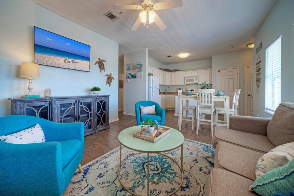 Coastal-inspired décor, plush seating, and a sleeper sofa in the living room. (203)