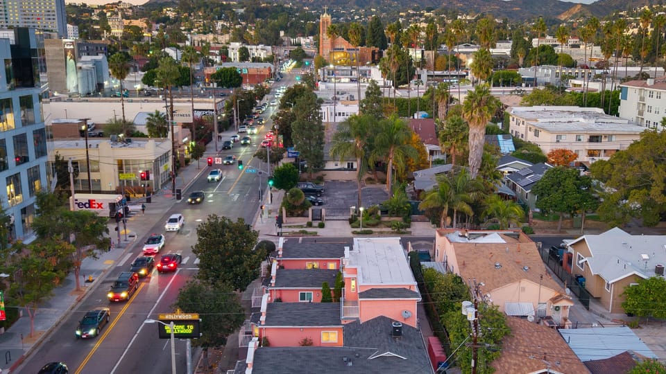 Aerial view of this charming pink retreat, nestled in a palm-lined neighborhood close to the city buzz.