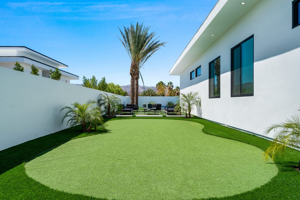 Aerial view of the modern luxury community with sleek homes, private pools, and scenic mountain backdrops.
