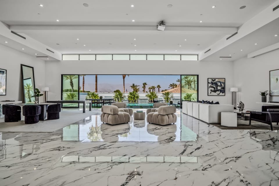 Aerial view of the modern luxury community with sleek homes, private pools, and scenic mountain backdrops.