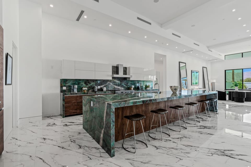 Aerial view of the modern luxury community with sleek homes, private pools, and scenic mountain backdrops.
