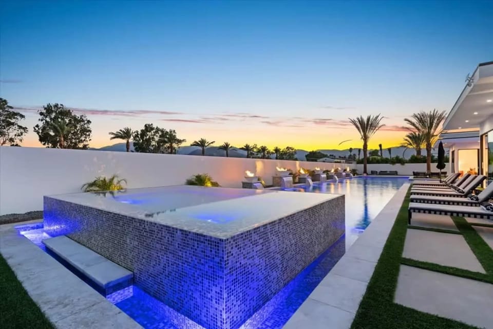 Aerial view of the modern luxury community with sleek homes, private pools, and scenic mountain backdrops.