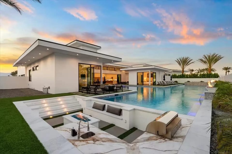 Aerial view of the modern luxury community with sleek homes, private pools, and scenic mountain backdrops.