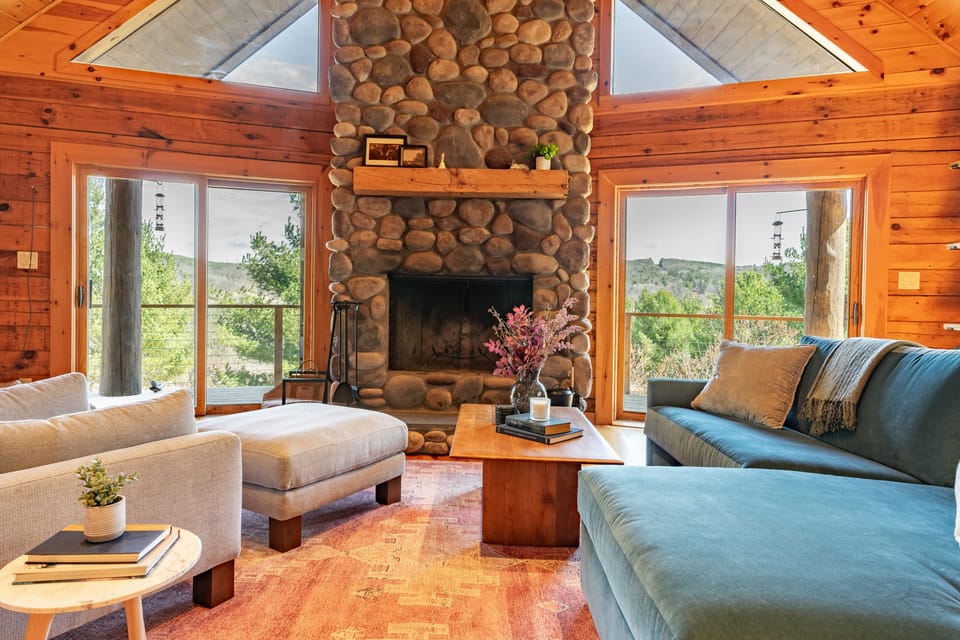 Living area with a floor-to-ceiling stone fireplace.