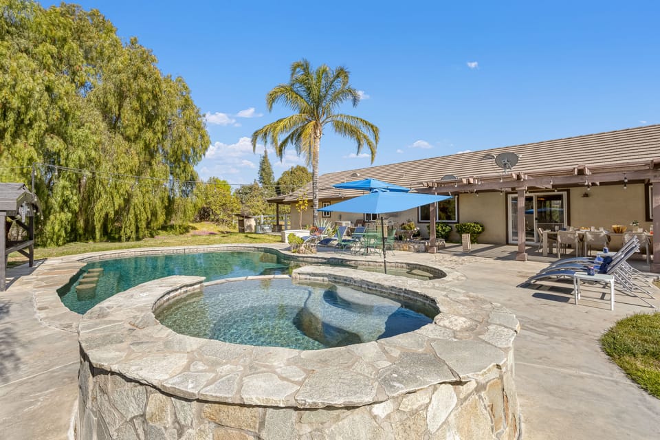 Relax and unwind in the pool and spa area, complete with cozy loungers for the ultimate retreat!