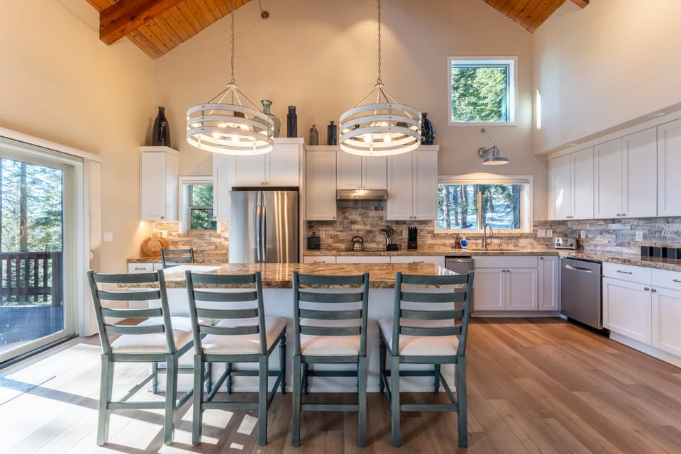 Large kitchen features an island with barstool seating.