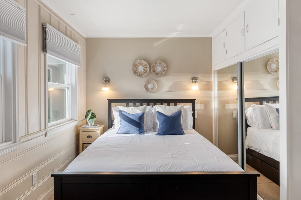 Restful bedroom space with plenty of natural light and storage.