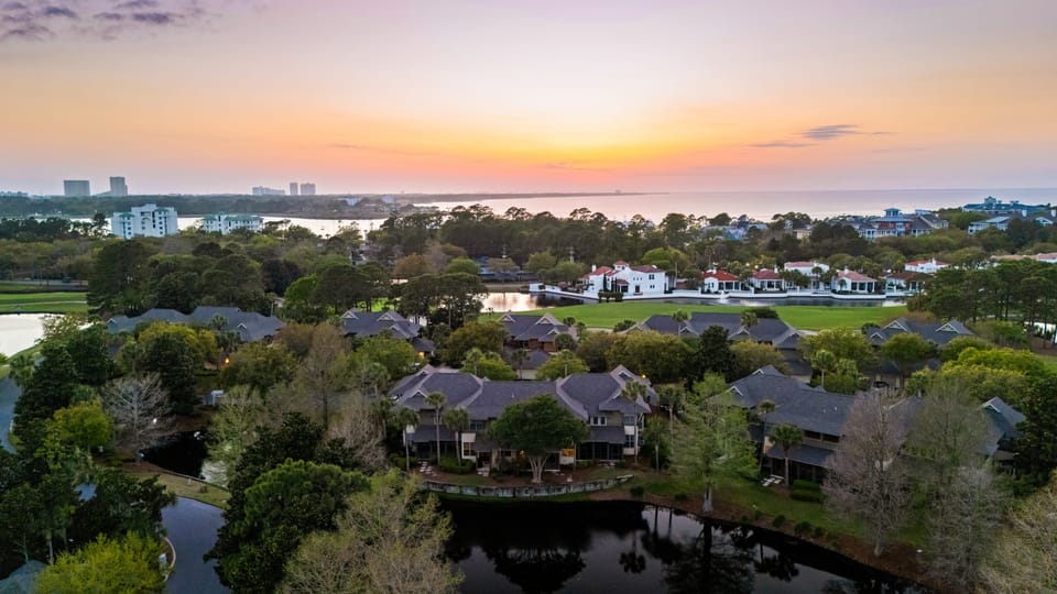 Broad aerial showing full property layout within a premier golf course setting.