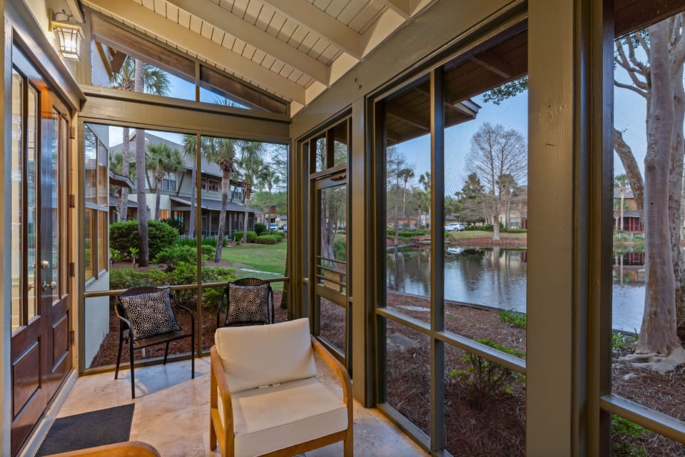 Additional angle of patio with elegant lighting and garden views.