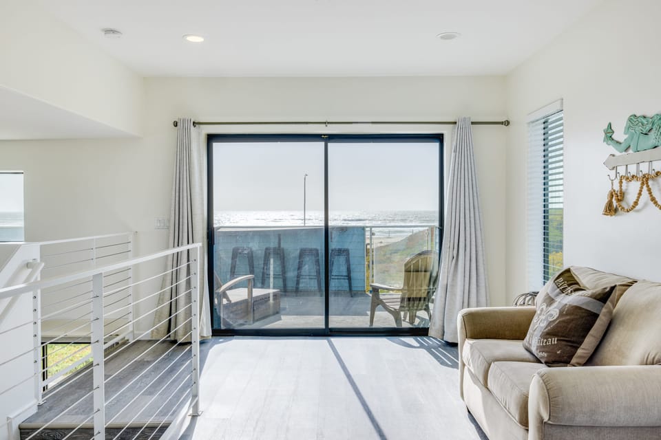 Sleeper sofa and balcony access.