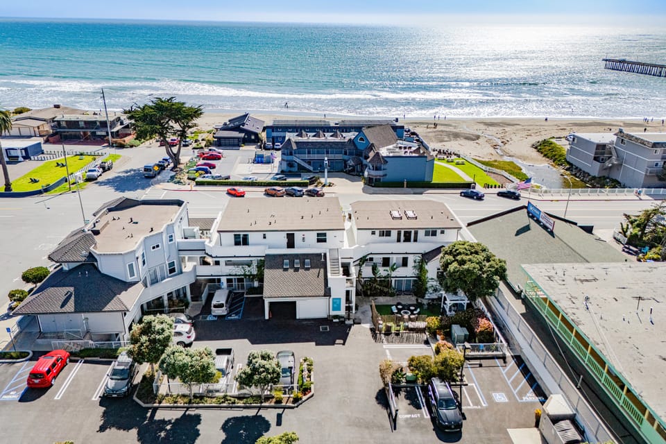 Aerial view of a charming seaside property and its surroundings.