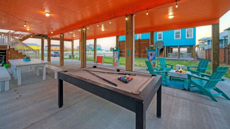 Fun awaits under the home for outdoor dining and games!