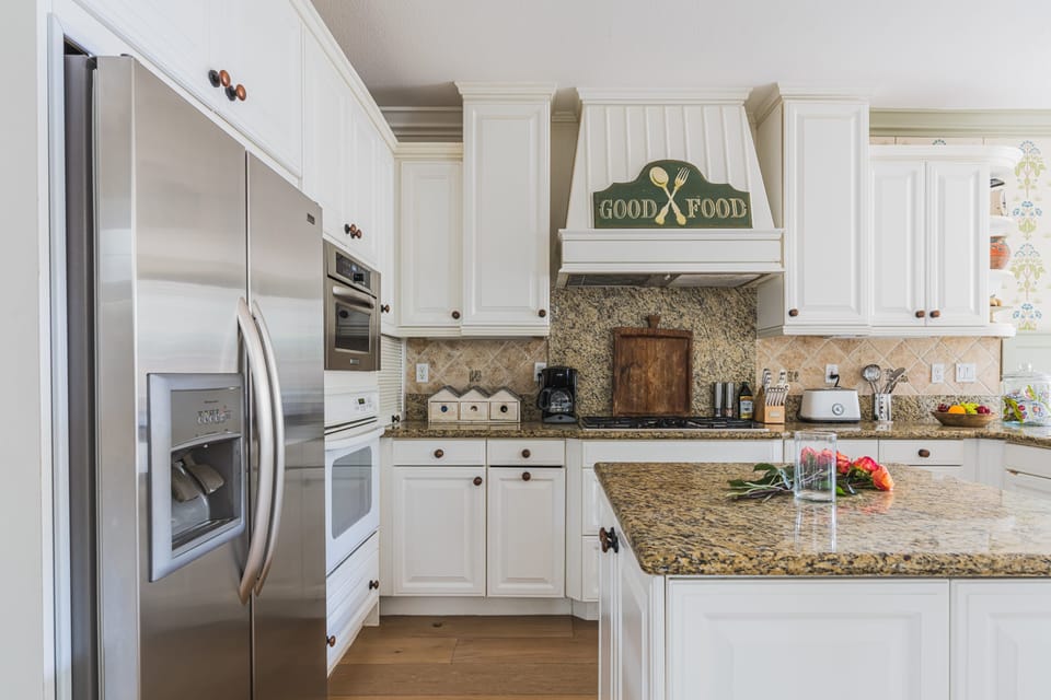 Fully stocked kitchen opens to breakfast area and lounge.