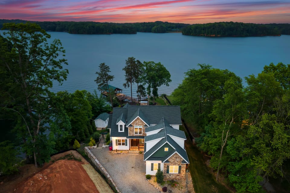Aerial view of our peaceful home on the lake, nestled among the trees.