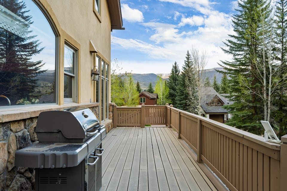 Uncovered deck with BBQ grill.